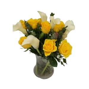 yellow roses and calla lilies in a glass vase