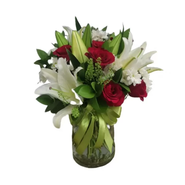 red roses and white lilies in a glass vase