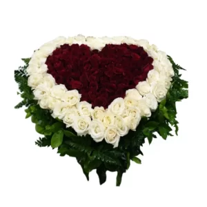 heart-shaped arrangement of white and red roses