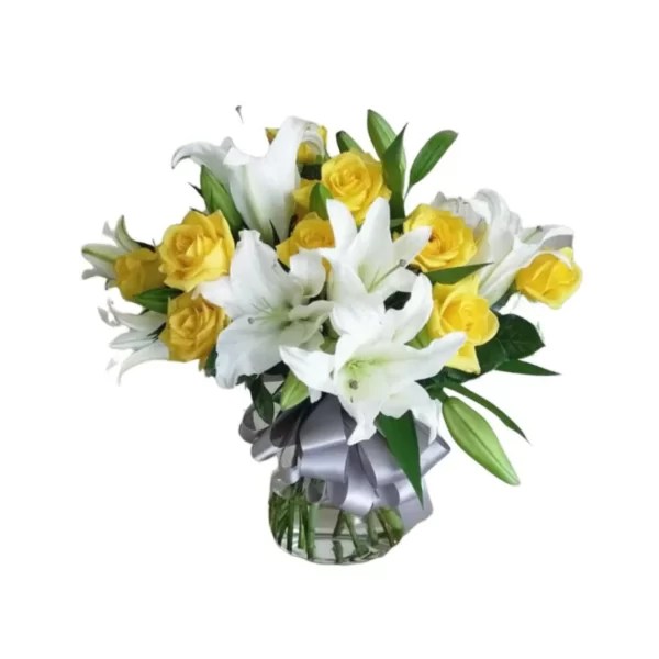 mixed flowers yellow roses and white lilies in glass vase