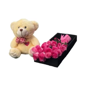 teddy bear and pink roses in a box